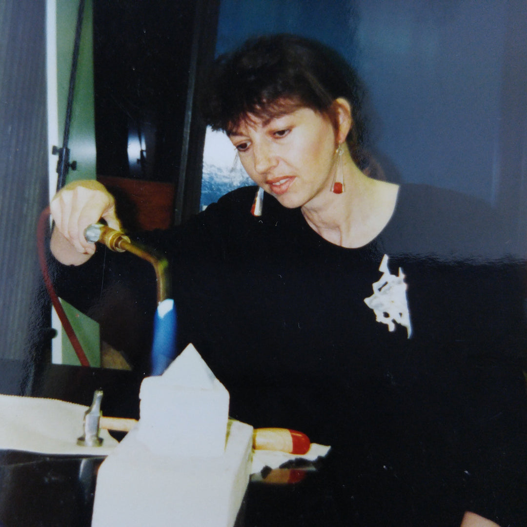Jeweler using a torch at the workbench
