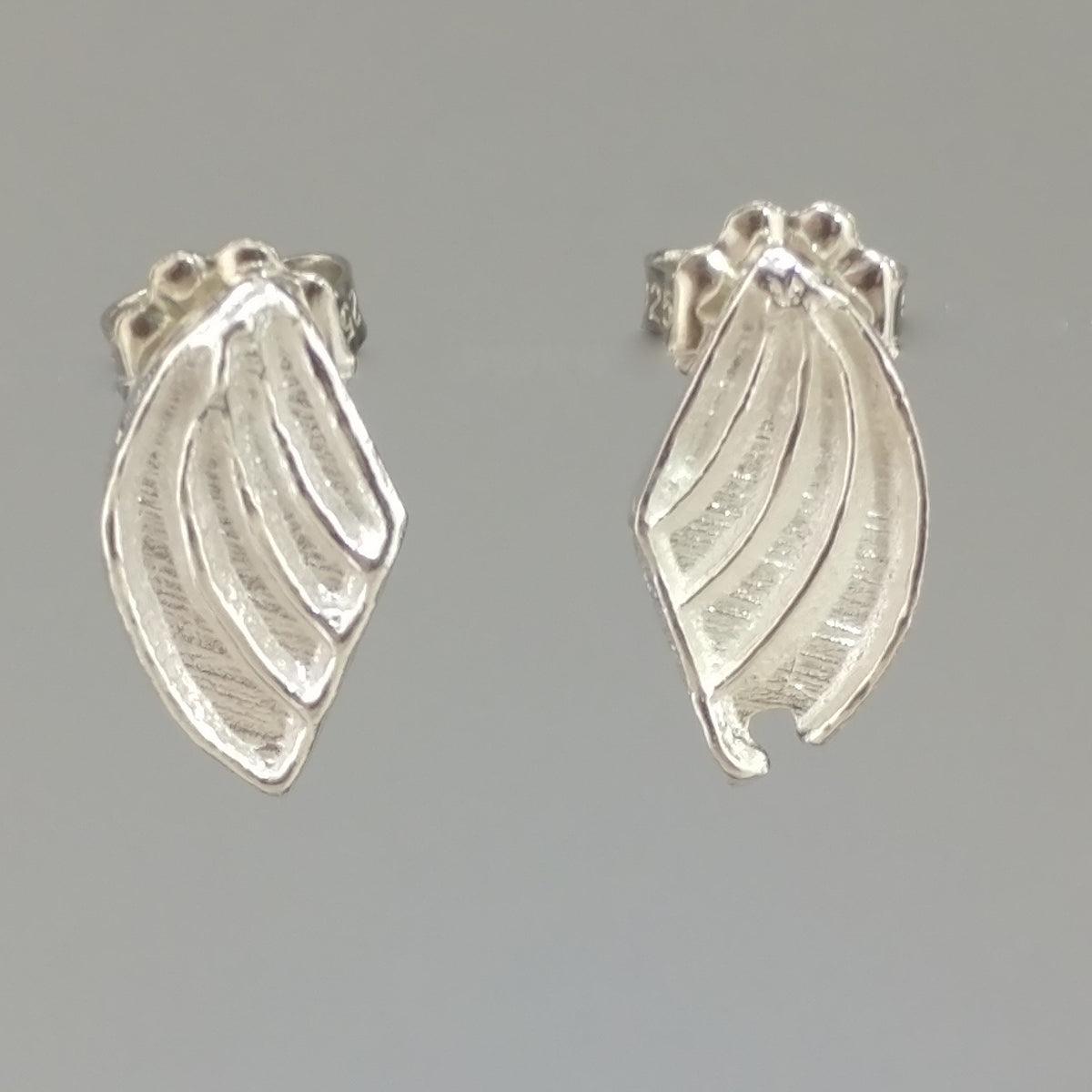 Pair of silver wing-shaped stud earrings