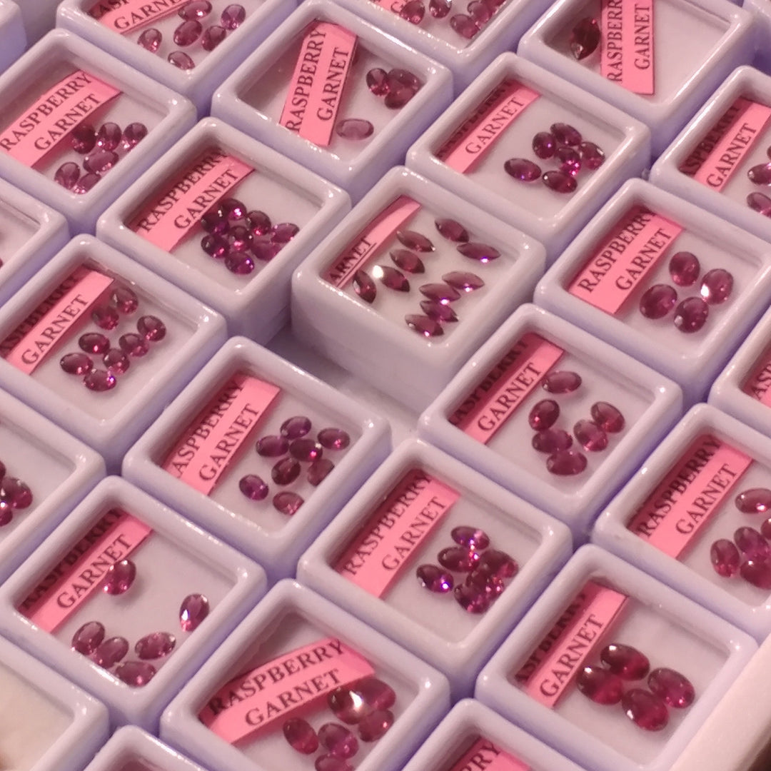 Display trays of loose raspberry garnet stones