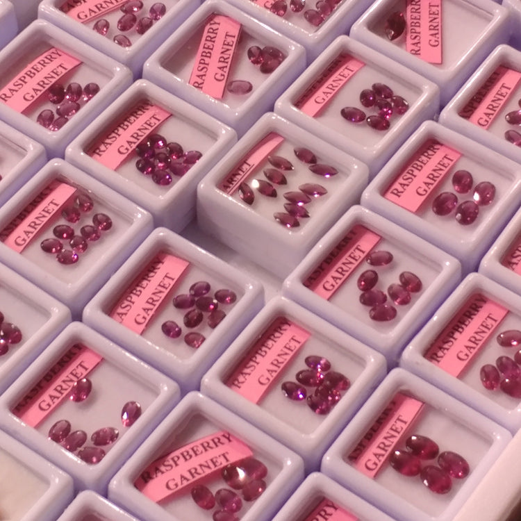 Display trays of loose raspberry garnet stones